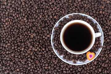 cup of coffee with heart on the background of coffee