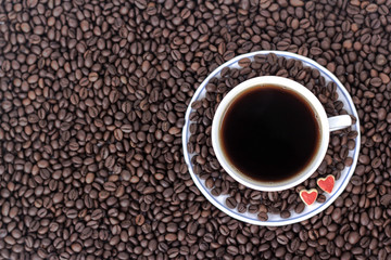 cup of coffee with heart on the background of coffee