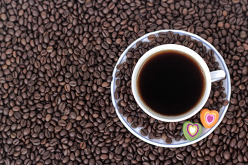 cup of coffee with heart on the background of coffee