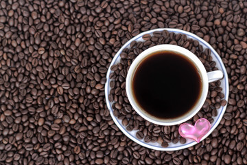 cup of coffee with heart on the background of coffee