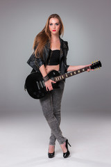 Fototapeta na wymiar Beautiful girl playing guitar