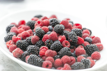 fresh blackberries and raspberries in a plate