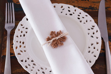 Christmas decoration: White plate serviette fork knife with  bro