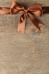 Old wooden background with beautiful bow
