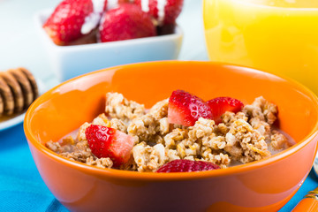Breakfast with mueasli with fresh fruit and orange juice