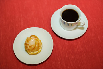 cup of coffee with cream puff
