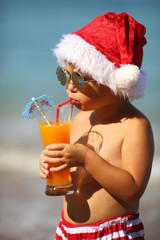 funny santa with a cocktail on the beach - 74786235