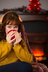 Beauty redhead drinking hot drink at christmas