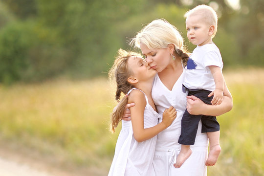 Mom With Son And Daughter In Summer Nature