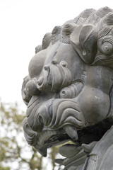 Fototapeta na wymiar Close up view of a beautiful lion statue on a park.