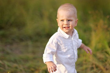 portrait of a Little boy playing in summer nature