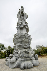 Fototapeta na wymiar Close up view of a huge beautiful Buddha statue on a park.