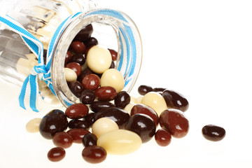 Colorful candies in glass jar isolated on white