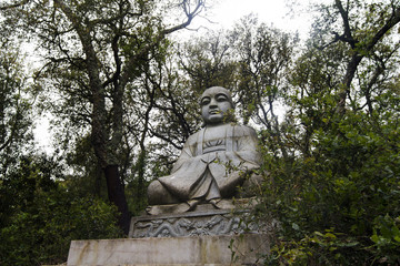 Obraz premium Close up view of a beautiful Buddha statue on a park.