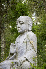 Fototapeta na wymiar Close up view of a beautiful Buddha statue on a park.