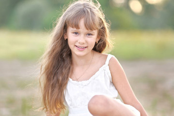 portrait of a little girl in summer nature