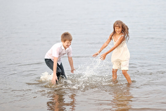 Portrait of a boy and girl playing on the beach