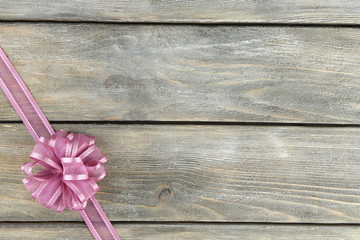 Old wooden background with beautiful bow