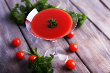 Tomato juice in goblet, parsley and fresh tomatoes