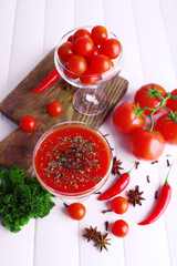 Tomato juice in goblet and fresh vegetables