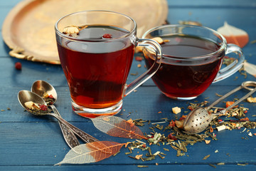 Beautiful vintage composition with herbal tea, on wooden table