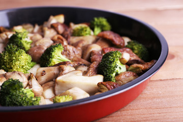 Braised wild mushrooms with vegetables and spices in pan