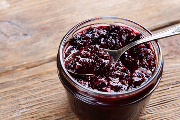 Delicious black currant jam on table close-up