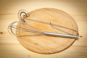 Steel beaters in the kitchen on a cutting wooden board