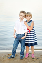 Portrait of a boy and girl on the beach in summer