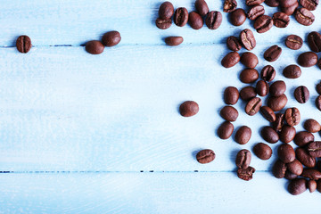 Coffee beans on the blue wooden background
