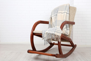 Rocking chair covered with plaid