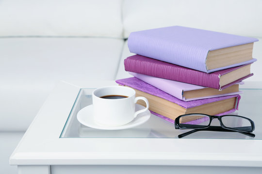 Purple books with cup and glasses