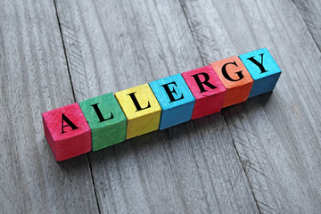 concept of allergy word on colorful wooden cubes