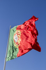View of a huge portuguese flag flapping in the wind.