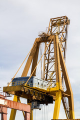 Fototapeta na wymiar View of silhouettes of crane towers in the docks.