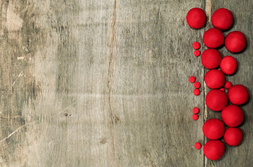 Naklejka na ściany i meble Place for text on wooden background and red felted beads