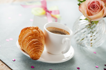 Romantic breakfast with coffee and croissant