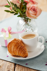 Romantic breakfast with coffee and croissant