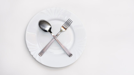 Fork, spoon and white plate