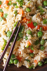 fried rice with egg, peas, carrots macro vertical top view
