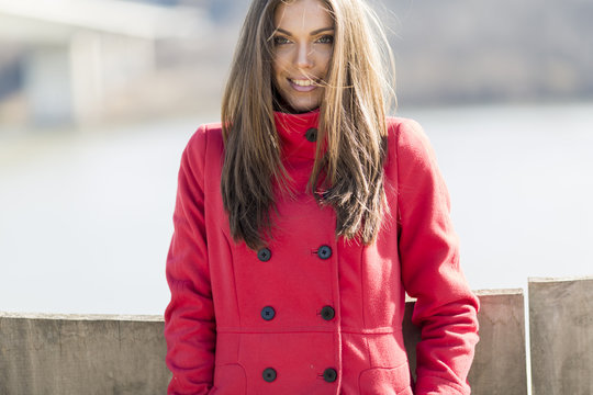 Pretty young woman in red coat
