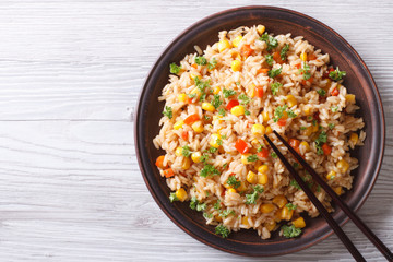 fried rice with eggs, corn and spice closeup horizontal top view