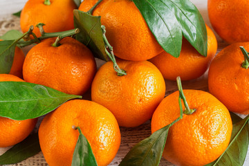 Tangerines with leaves on a wooden table