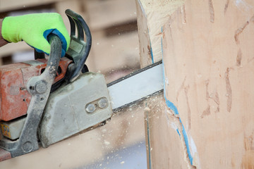 cutting wood with chainsaw