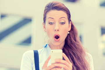 anxious young girl looking at phone seeing bad news or photos wi