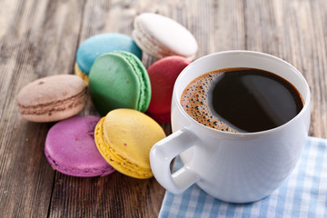 Cup of coffee and french macaron.