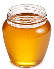 Opened glass can full of honey.