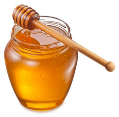 Glass can full of honey and wooden stick on it. Clipping paths.