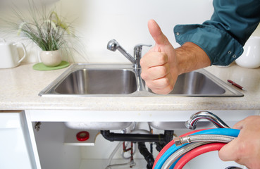 Obraz na płótnie Canvas Plumber on the kitchen.