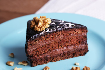 Fototapeta na wymiar Delicious chocolate cake on plate on table close-up